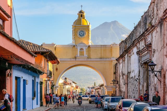 Santa Catalina Arch and the volcano-framed central streets in Antigua Guatemala, Guatemala